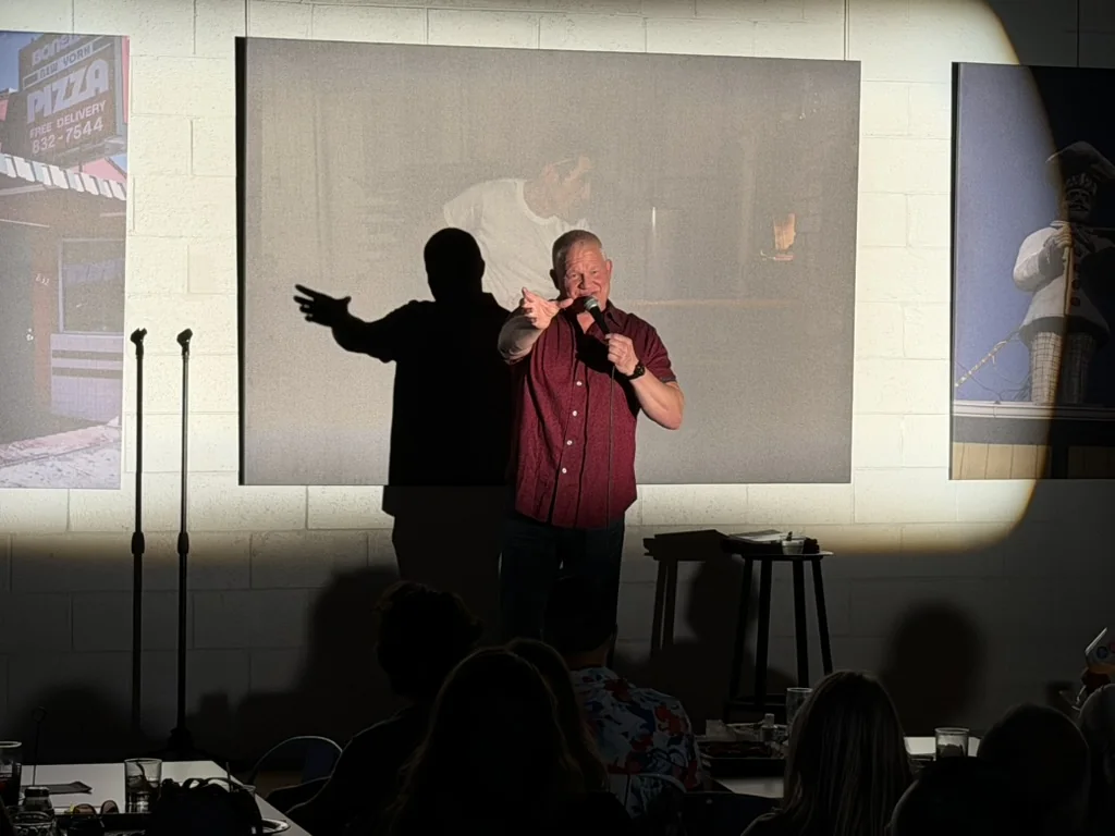 Derek Richards performing under the spotlight at HOMES Campus