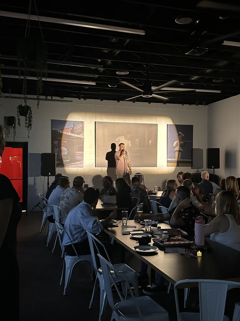 AKlutch founder Anson Kairys welcoming the audience at the July comedy show